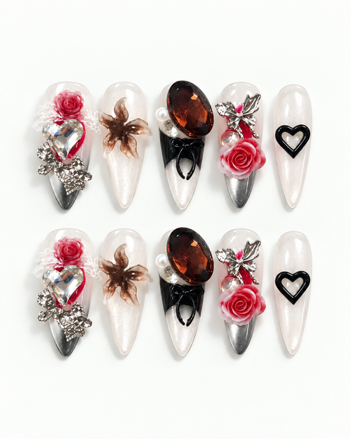 Handmade long almond press-on nails with sculpted red roses, oversized crystals, pearls, silver details and black heart accents