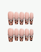 Handmade nude pink leopard press-on nails with crystal edging in long coffin and oval shapes