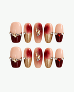 Handmade burgundy nude and gold medium coffin press-on nails with red heart gem pearls crystals and metallic charms