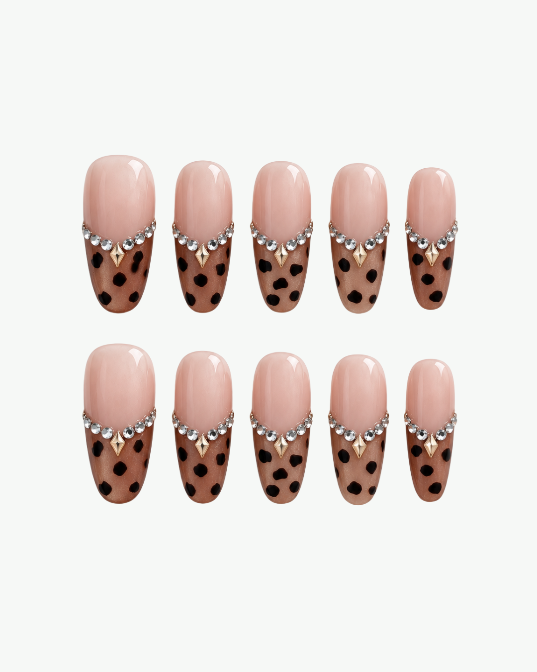 Close-up of nude pink leopard press-on nails with sparkling crystal border detailing