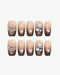 Handmade nude and mocha brown short coffin press-on nails with shimmer, clear crystal clusters and pearl accents
