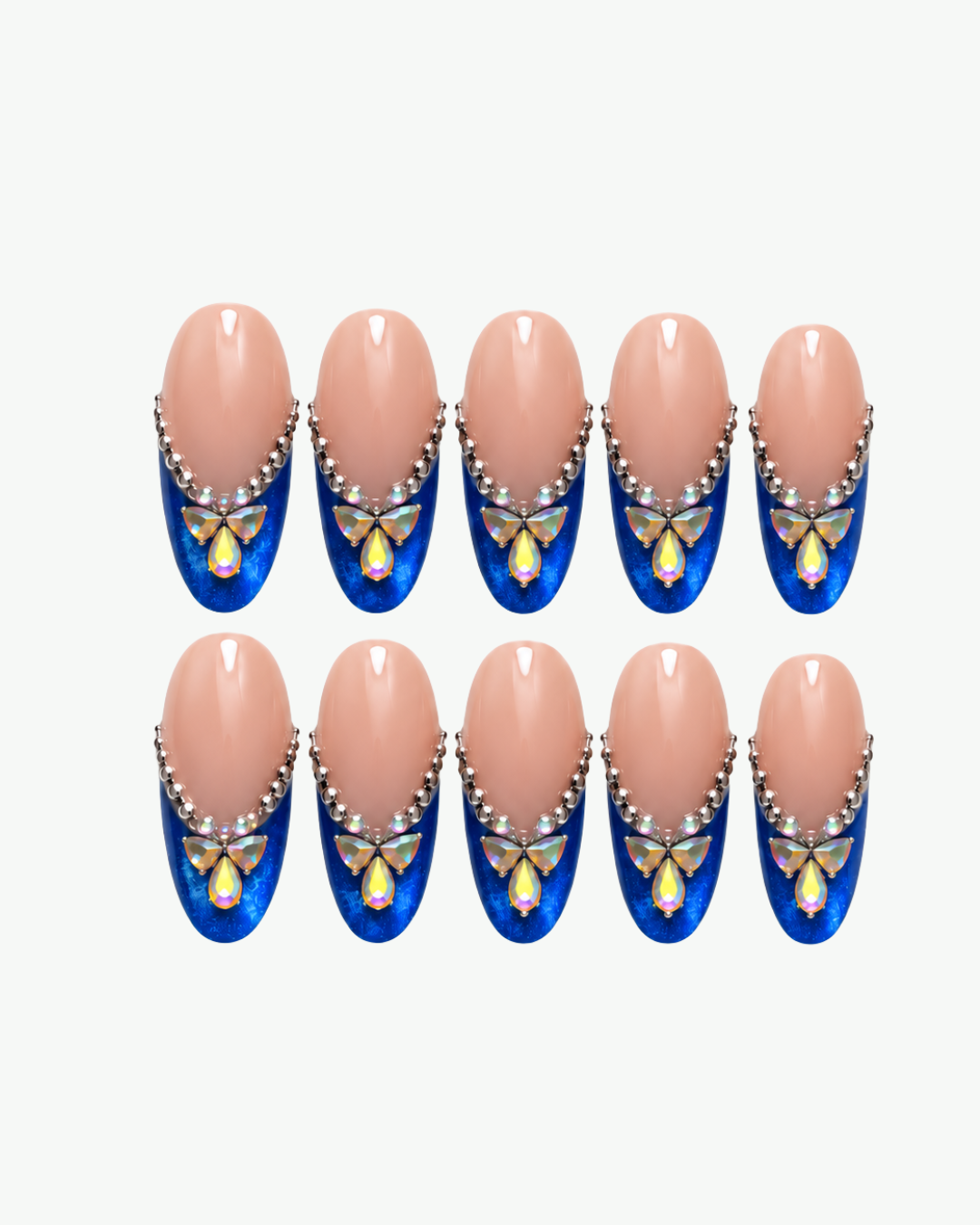 Handmade nude and navy blue press-on nails with iridescent butterfly crystals and rhinestone detailing