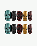 Handmade multicolour short oval Halloween press-on nails with skull-inspired faces and stitched graphic details
