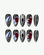 Handmade silver and red almond press-on nails with 3D floral, marbled and chrome-inspired detailing