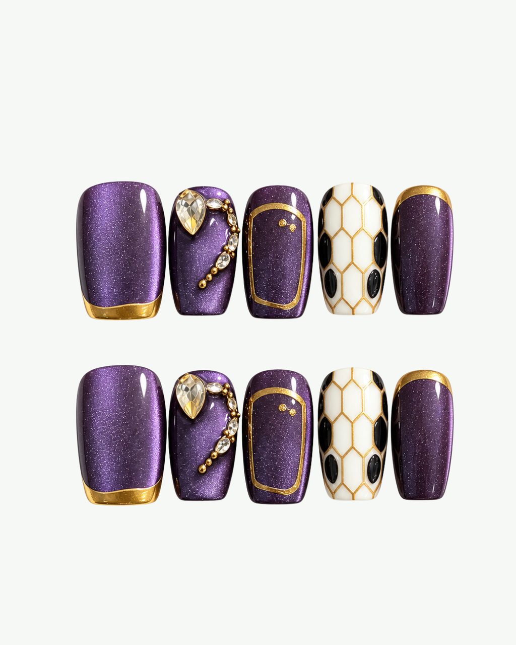 Handmade purple squoval press-on nails with gold snake-inspired details, crystal accents and black and white scale design