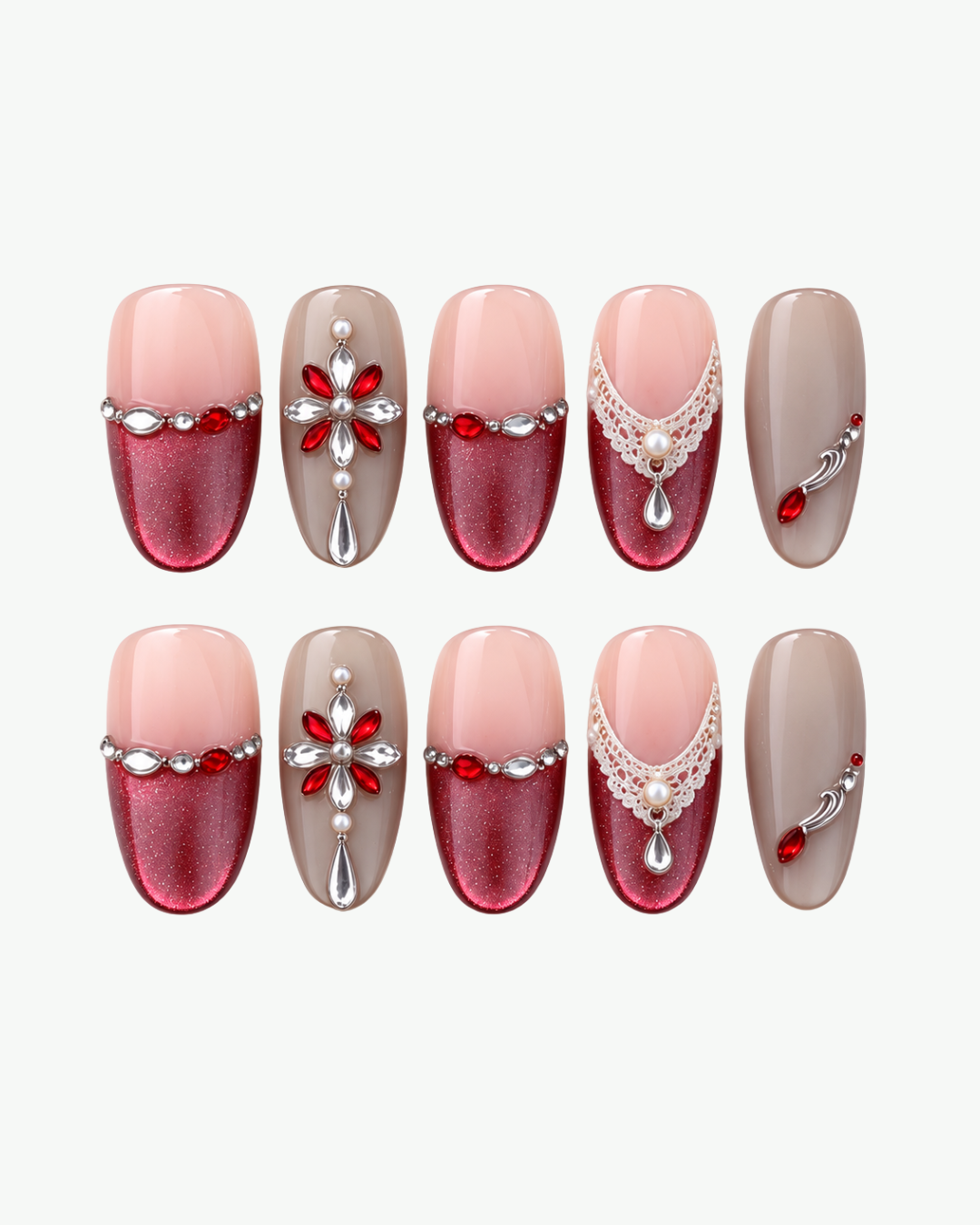 Handmade nude and red oval press-on nails with crystal embellishments and lace-inspired detailing