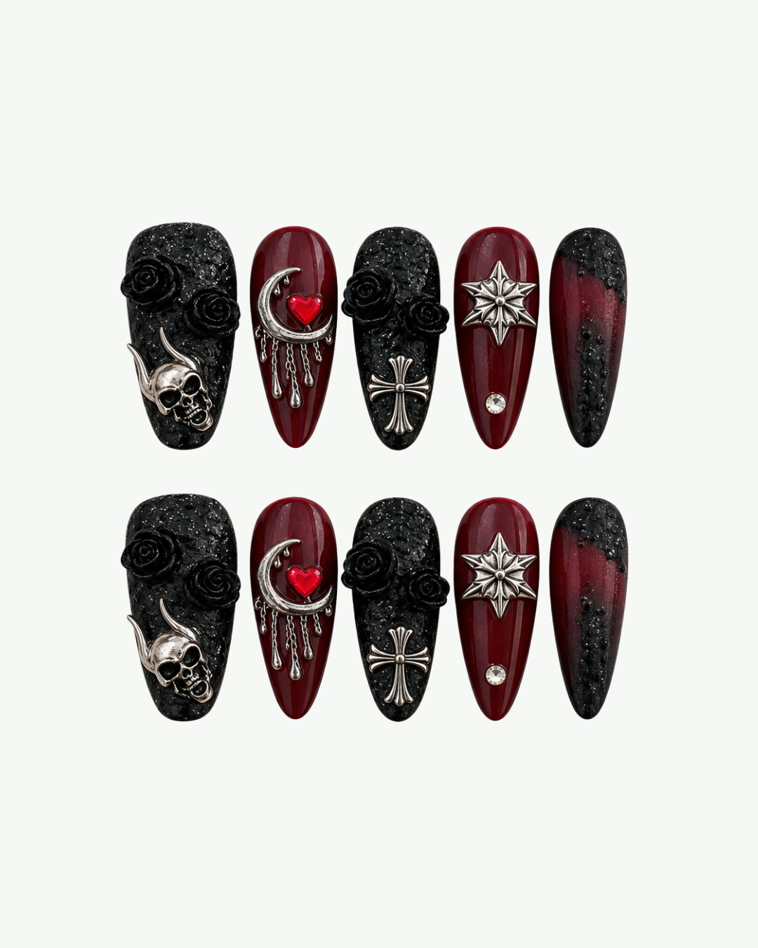 Close-up of burgundy and black gothic press-on nails with metallic charms crystals and sculpted details
