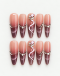 Extra long stiletto press-on nails with blush-to-plum ombre, pink snake detail, pearls and crystal accents